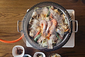 Nabe Japanese hot pot dishes including prawns, salmon, pork, vegetables and mushrooms at the restaurant in Hokkaido, Japan