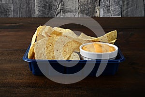 Nacho chips with cheese in blue container