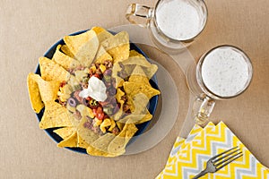 Nachos with beef, jalapeno peppers, olives, tomato, beans, cheese and sour cream