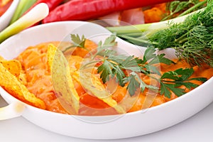 Nachos, cheese sauce, vegetables