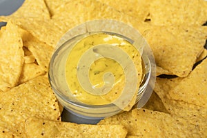 Nachos corn chips in cheese sauce with selective focus, horizontal banner format