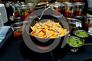 Nachos with guacamole and salsa in catering setup