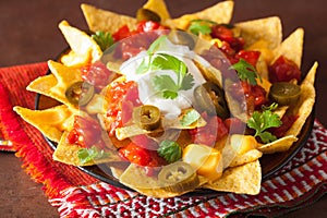 Nachos loaded with salsa, cheese and jalapeno