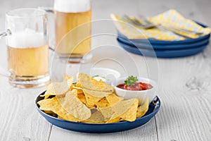 Nachos with salsa and sour cream dips