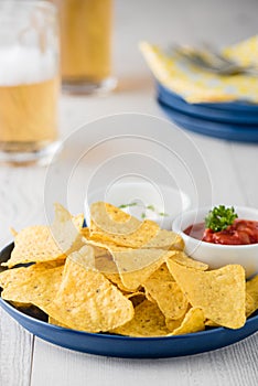 Nachos with salsa and sour cream dips