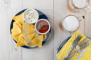 Nachos with salsa and sour cream dips