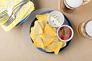 Nachos with salsa and sour cream dips