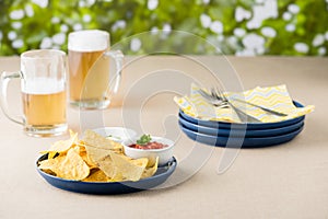 Nachos with salsa and sour cream dips