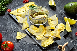 Nachos. Tortilla Chips with Guacamole on stone background