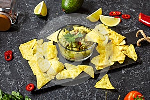 Nachos. Tortilla Chips with Guacamole on stone background