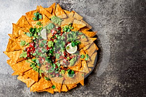 Nachos. Totopos with sauces. Mexican food concept. Yellow corn totopos chips with different sauces salsas - pico del