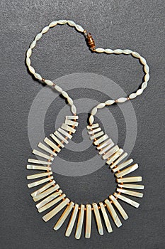 Nacre necklace on black textured wooden table