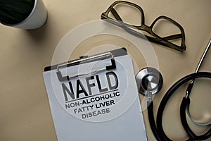 NAFLD - Non-Alcoholic Fatty Liver Disease write on a paperwork isolated on office desk photo