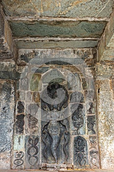 A Naga Queen surrounded by snakes sculpture at Chennakeshava Temple in Belur, India photo