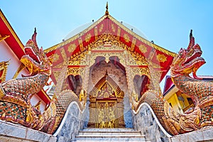 Naga serpents and gilt facade of Ubosot in Wat Thung Yu, Chiang Mai, Thailand