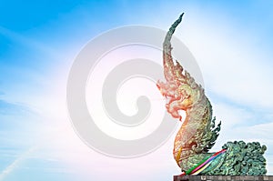 Naga statue spray water to the sea with blue sky background