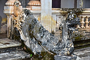 Naga statues adorn the stairs of an ancient church in Wat Luang Pakse