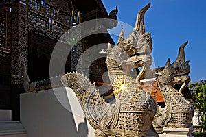 Naga statues protect the entrance to Thai temples