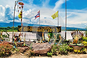 Nagas and flags on the grounds of the temple Wat Along Silawat, province Bueng Kan, Thailand