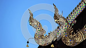 Nagas framing the pitch of temple roof