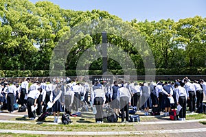 Nagasaki, Japan. High school students bow in memory of victims of U.S. atomic bomb drop at the memorial in Peace Park.