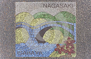 Asphalt illustration depicting the Meganebashi or Spectacles stone Bridge on the ground of Isahaya city.