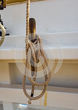 Nagel and coil of rope on the white board of the old schooner photo