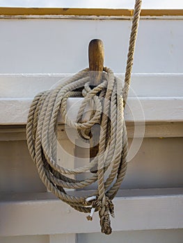 Nagel and coil of rope on the white board of the old schooner photo