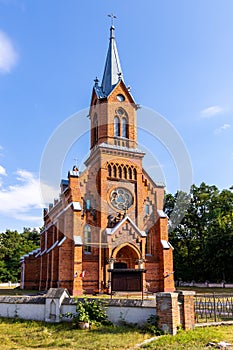 Neo-gothic parish church of St. Mary Rosary near park and historic museum manor house of Mikolaj Rej, polish renaissance poet and photo