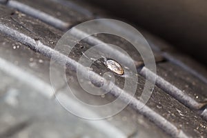 Nail in a car tyre causing puncture photo