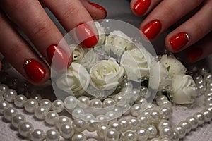 Nail design with white flower and beads