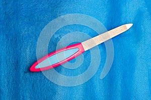 Nail file close-up on a blue background photo