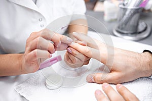 Nail grooming on the man hands during manicure treatment