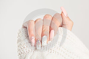 Nail Polish. Art Manicure. Modern style blue Nail Polish.Stylish pastel Color pink white Nails holding wool material sleeve blouse