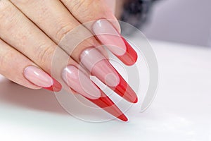 Nail Polish. Art Manicure. Modern style red black gradient Nail Polish. Beauty hands with Stylish Colorful trendy Nails w