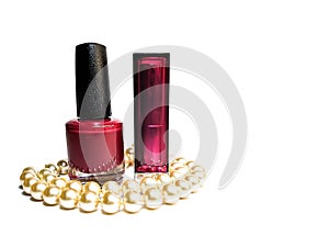 Nail polish, bard-colored closed lipstick and white pearl beads on a white background
