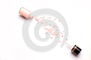 Nail polish bottle and drops on white background