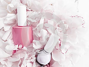 Nail polish bottles on floral background, french manicure and cosmetic branding