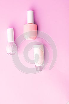 Nail polish bottles on pink background, beauty brand