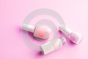 Nail polish bottles on pink background, beauty brand