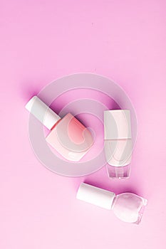 Nail polish bottles on pink background, beauty brand