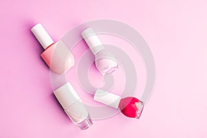 Nail polish bottles on pink background, beauty brand