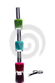 Nail polish bottles pyramid with scissors