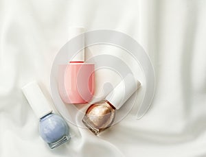 Nail polish bottles on silk background, french manicure products and nailpolish make-up cosmetics for luxury beauty brand and