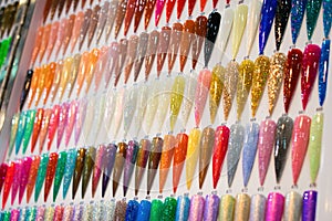 Nail Polish Color Charts. Nail polish swatches in different color. Colorful nail lacquer in tips. Shiny gel lacquer