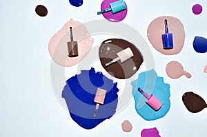 Nail polish enamel mixed multicolor samples, isolated on white background