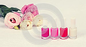 Nail polish for french manicure and a bouquet of roses