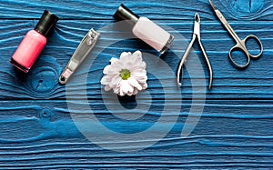 Nail polish and manicure set on dark wooden background