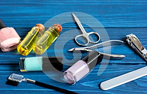Nail polish and manicure set on dark wooden background