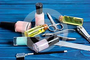 Nail polish and manicure set on dark wooden background